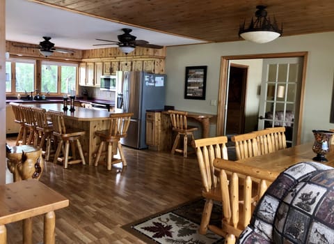 The spacious kitchen features cedar log stools (6) and cedar table/chairs (10)