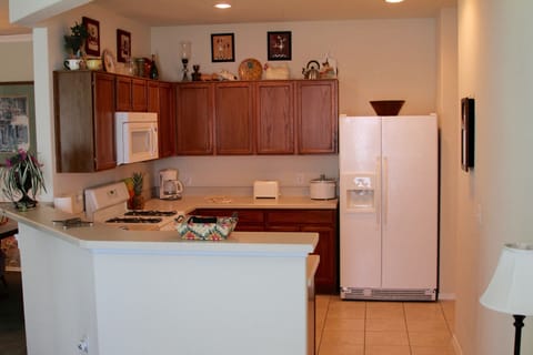 The kitchen is well equipped w/ side by side fridge, microwave, oven & dishwashe