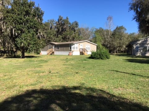 The house sits away from the street which is on a dead end road. 