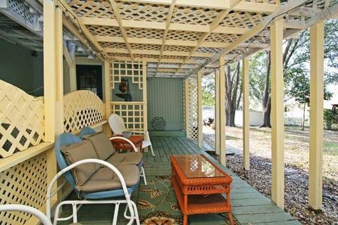 Back porch overlooking large back yard with huge shady canopy of Oak Trees.