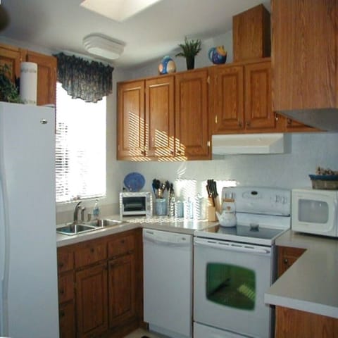 fully equipped  kitchen with island,  skylight, icemaker, microwave, and more 