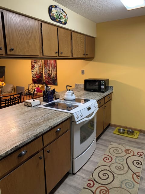 Well stocked kitchen with plenty of cooking utensils.