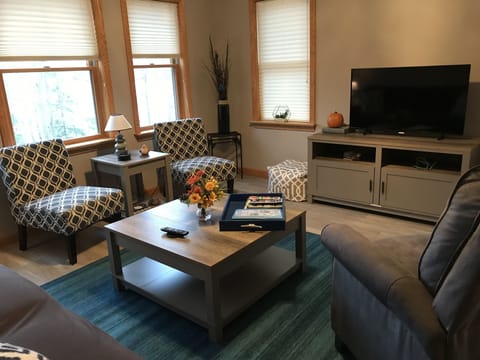 living room area with queen size sleeper sofa, smart TV and recliner