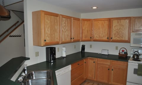 Kitchen includes dishwasher along with coffee, tea, and condiments.