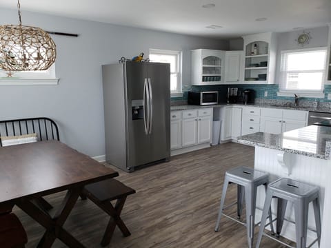 Dining Area into Kitchen and Breakfast Bar. Bar has USB port/electrical plugs