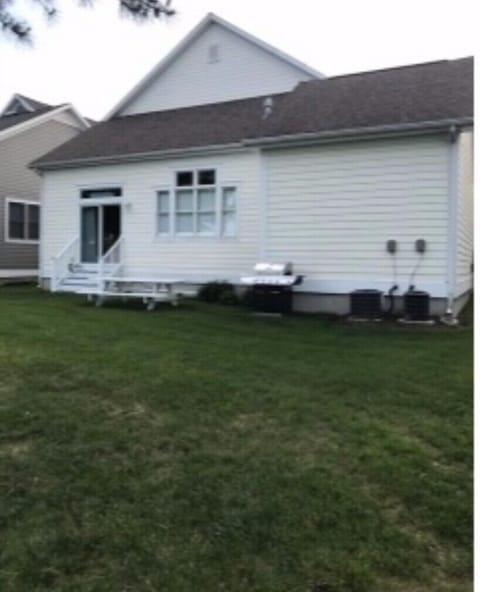 back of house with picnic table and luxury propane grill