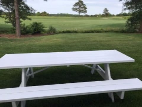 8+ person picnic table in back yard facing 2nd hold of golf course