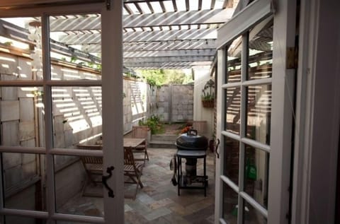 Small private backyard patio with BBQ. Outside shower too!