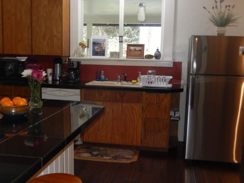 Kitchen has stainless steel oven/stove, refrigerator, microwave & dishwasher...
