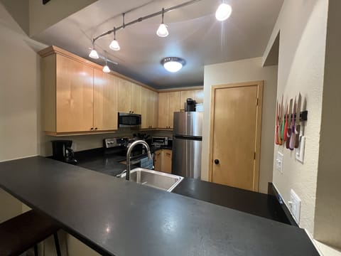 Fully stocked kitchen with granite counters and modern appliances