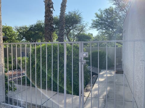 Front privacy gate to home, two car garage to right, front entrance to left