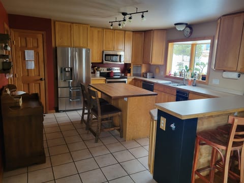 Kitchen with plenty of seating at the island & bar. Large pantry.