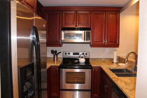 Full kitchen with full size fridge, stove/oven, dishwasher, and microwave