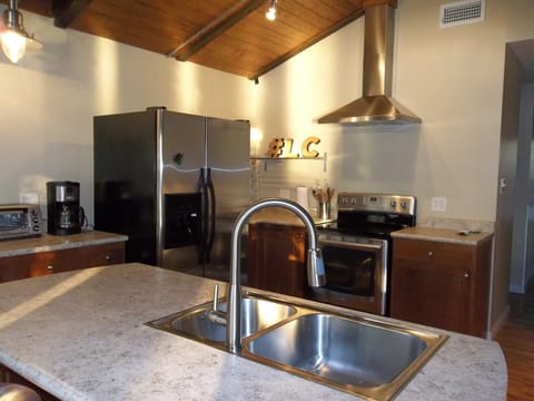 Renovated kitchen with stainless steel appliances.