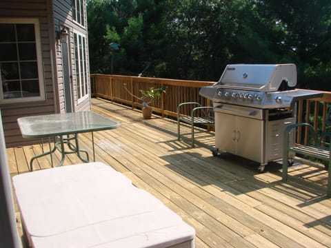 Deck with table and grill ready to entertain