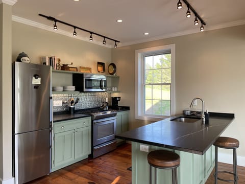 Fully stocked kitchen with soapstone countertops and new appliances. 