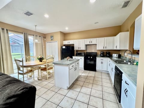 Huge open kitchen and breakfast area with direct access to the pool area