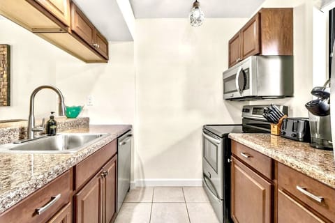 Kitchen w/ a dishwasher, electric stove, microwave, refrigerator, and a freezer.
