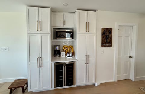 Microwave, Wine & Beverage Fridge, Coffee Maker, & an assortment of Café Syrups