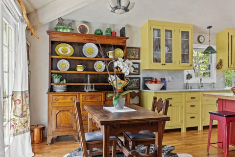 Cozy dining nook with antique hutch and modern kitchen blend