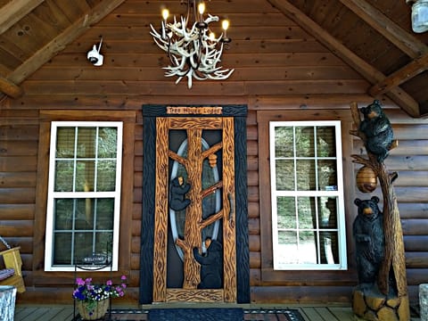 Front View Of Lodge With Locally Handcrafted Door & Bear Statue