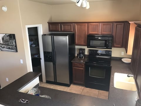 Open concept kitchen, stocked with all of the necessities and a large pantry 