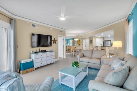 The living area features a 65" Smart Cable TV and DVD Player