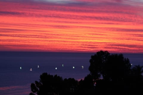 Squid fishing boats at sunset as seen from the deck..