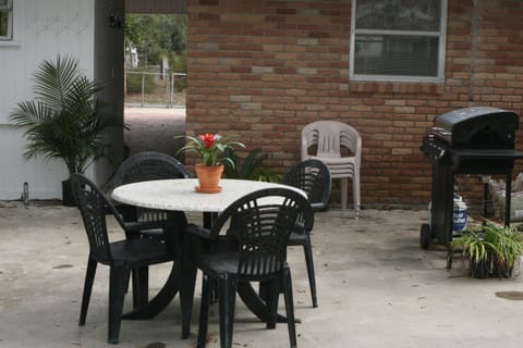 Outdoor living on the back patio...new gas grill, beautiful live oak trees!