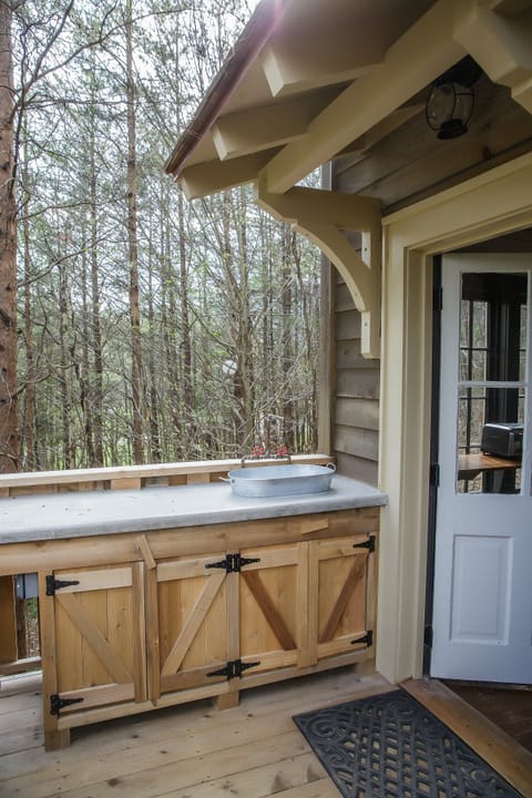 outdoor kitchenette with concrete countertop and galvanized steel sink 