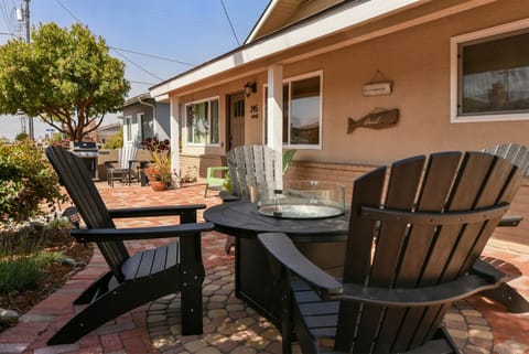 Enjoy the patio area with comfortable seating, fire pit, and a Weber barbecue grill.