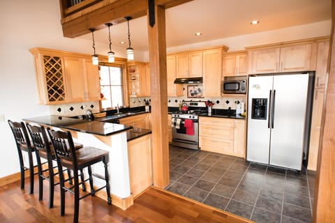 Full kitchen with 3 bar stools.  Gas stove, washing machine, microwave, coffee