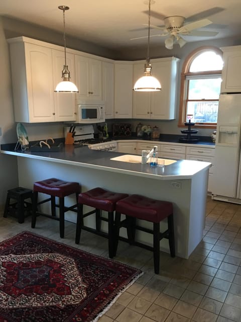 Lg kitchen w/dishwasher, gas stove, microwave, fridge; loads of pots/pans/dishes