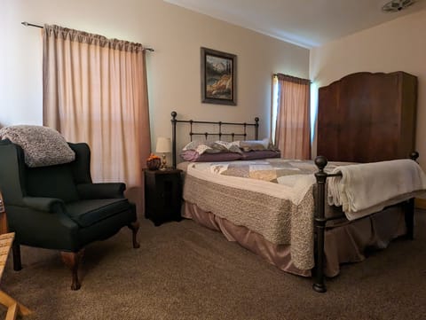 Comfortable master bedroom with queen size bed for peaceful nights' sleep.