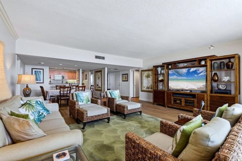 Relax in your spacious living room with tropical touches, cozy seating, and entertainment center—perfect for unwinding after beach days.