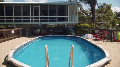 Ridiculously relaxing screened in porch overlooks large pool and huge pool deck.