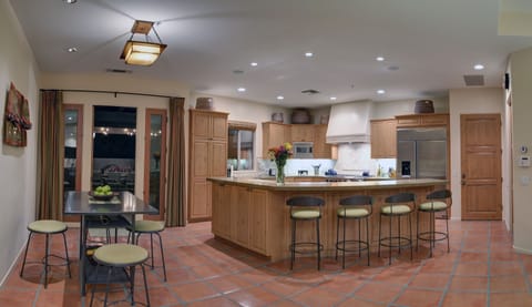 View of kitchen, bfast nook and outdoor pavilion from great room seating area