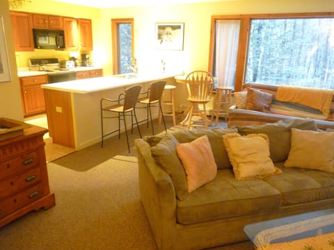Upper level view from living room towards kitchen. Extra large windows. Hideaway 