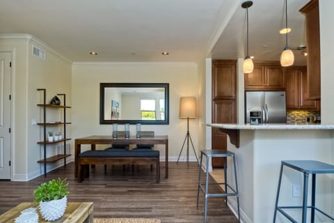 View of dining room and bar seating adjacent to kitchen