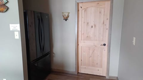 2nd refrigerator and freezer located in the living room, behind sectional sofa.