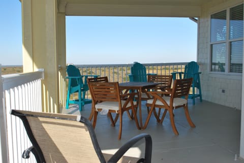 Large balcony views the wetlands and dunes of West Galveston Island