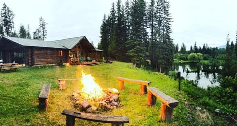 Spring campfire by fire pit in the back of cabin