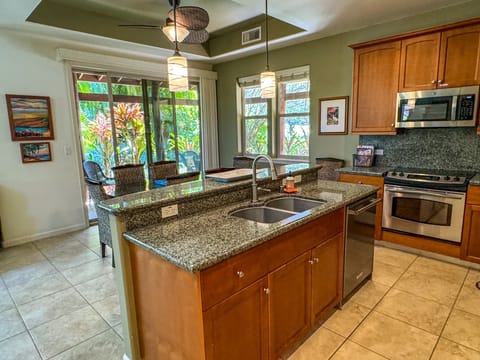 Spacious kitchen, with nice dishes, cooking utensils and high quality pots/pans
