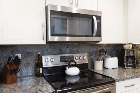 Stainless appliances, granite counter tops and fully stocked kitchen