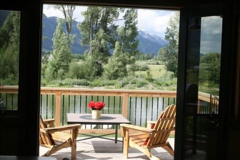 inviting view from inside of the deck, pond and Tetons.