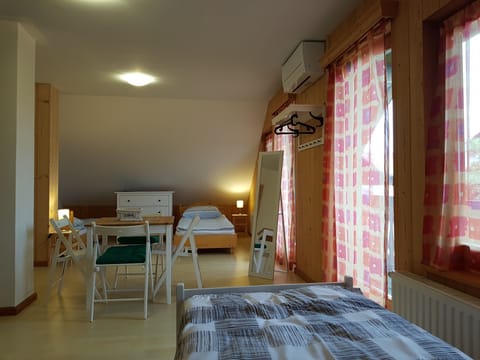 room with 4 single beds and air condition