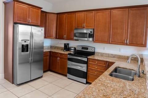 Kitchen with granite counters, hard wood cabinets, and high end appliances.