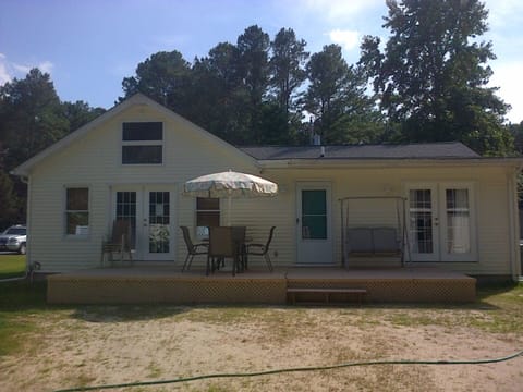 Back of the house with furniture and grill 