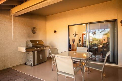 Jenn-air 4 burner BBQ and covered seating for 4. Extra chairs in garage.