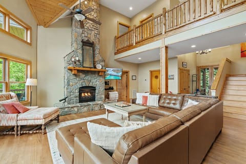 Two Story Stone Gas Fireplace in the open concept first floor. 